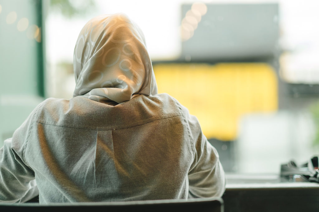 EARS - Veiled woman seen from the back